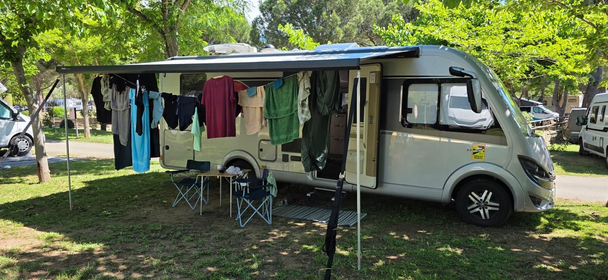 Our motorhome with the awning out and washing strung across a line underneath, the awning doubling as a drying room